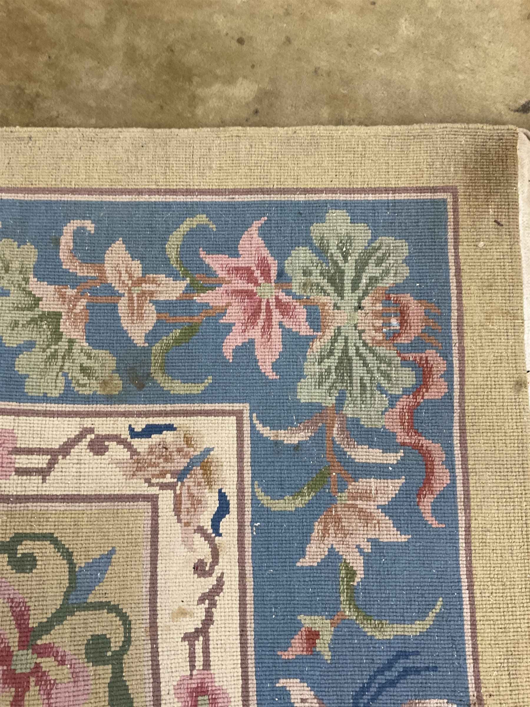 Large Chinese washed woollen carpet, pale sage green ground and decorated with flowers