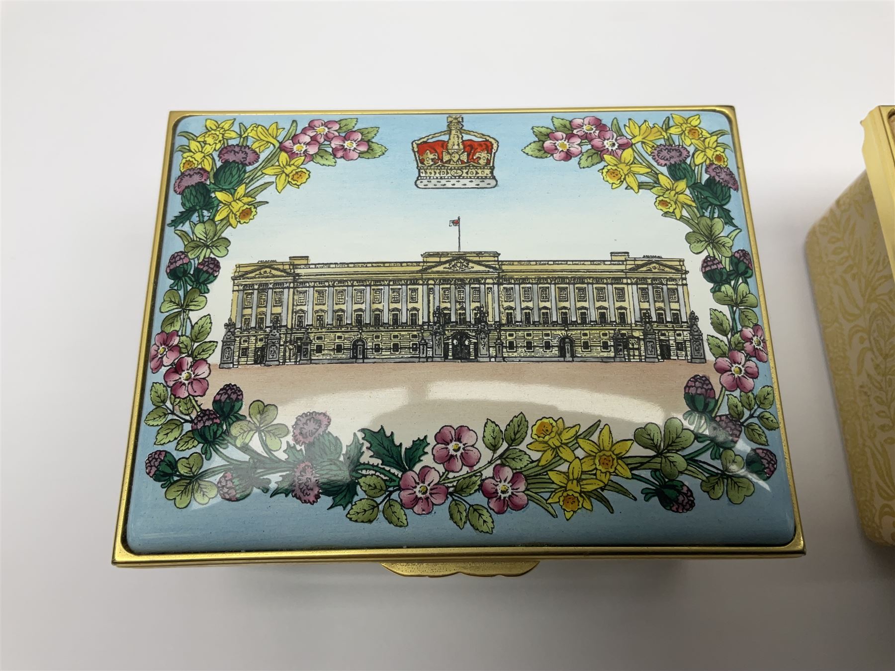 Two Halcyon Days enamel boxes, both of rectangular form, the first depicting Buckingham Palace, 'To Celebrate the Golden Jubilee of Her Majesty Queen Elizabeth', the second depicting the marriage of The Queen and Prince Philip, in celebration of their Diamond Wedding Anniversary, H4cm, W8.5cm, both boxed