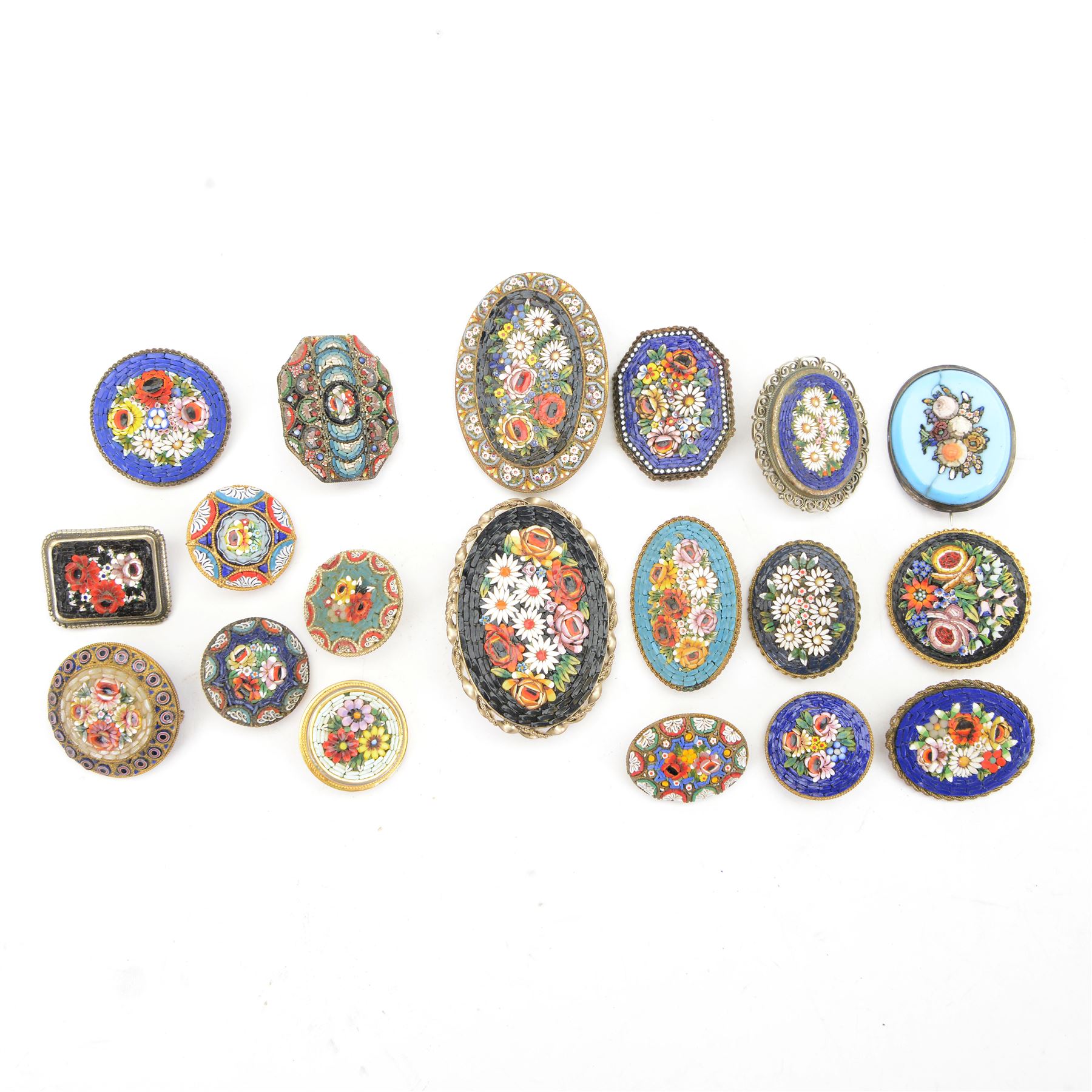 Nineteen micro mosaic brooches, all decorated all with floral decoration to the centre