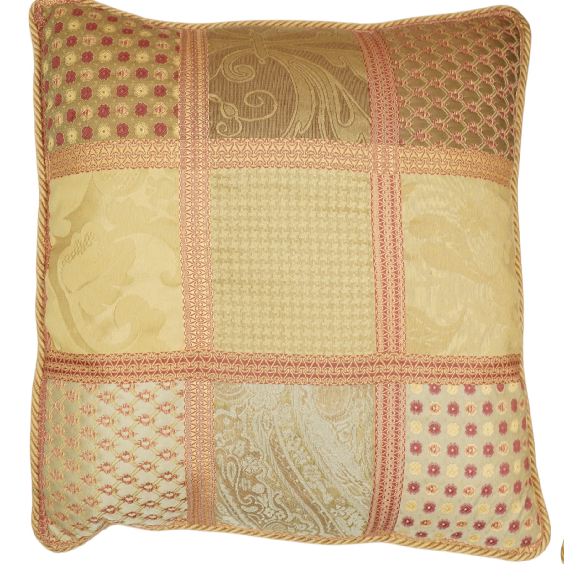 Contemporary set of six jacquard woven scatter cushions, each with a patchwork effect of floral, damask and dotted motifs in a palette of gold, blush, and cream, piped edging throughout, together with a square cushion with embroidered tree and bird design on a cream linen ground (H 40cm, W 40cm, D 14cm)
