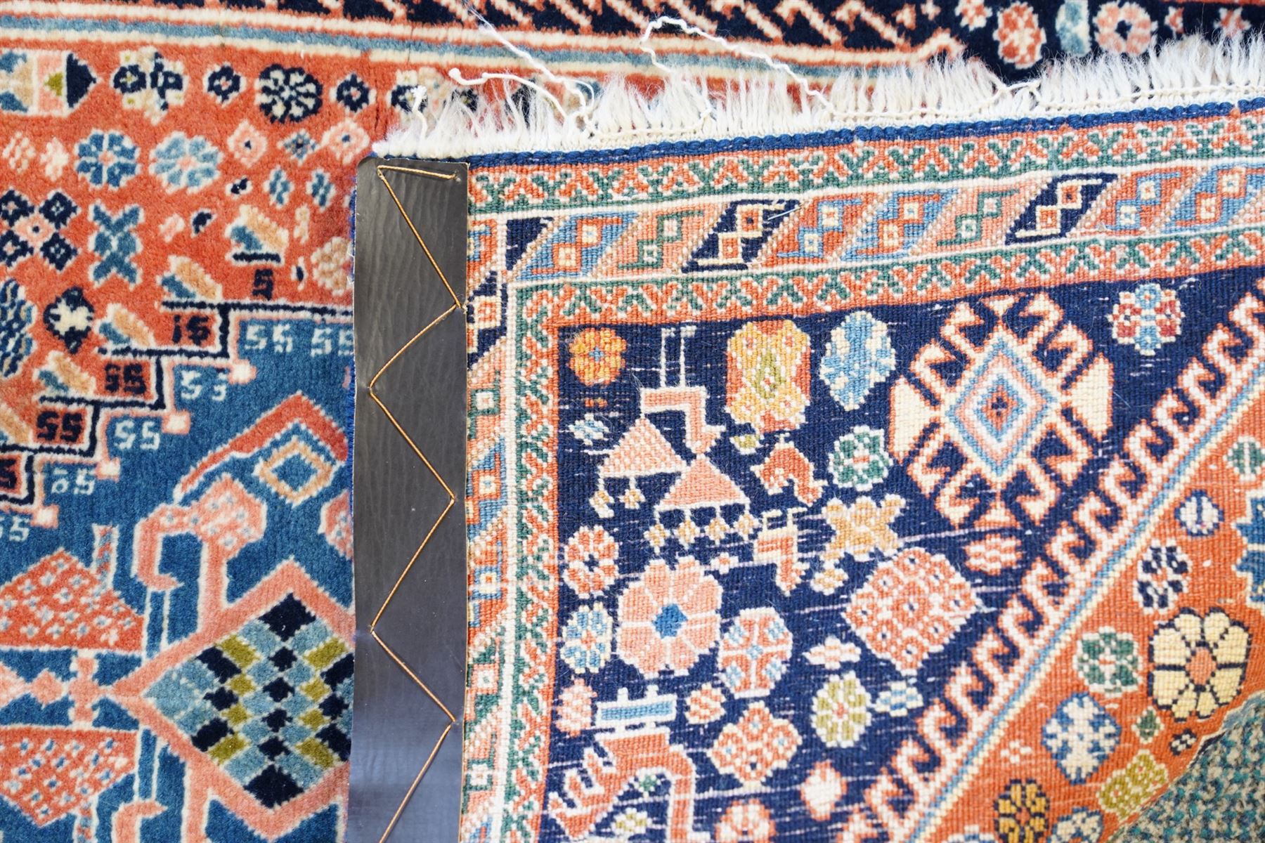 Small Afghan rust ground rug, plain field enclosed by patterned borders (94cm x 64cm); small Persian Hamadan indigo ground rug, decorated all-over with small flower head and bird motifs (118cm x 66cm); and a small Persian red ground rug (94cm x 62cm) (3)