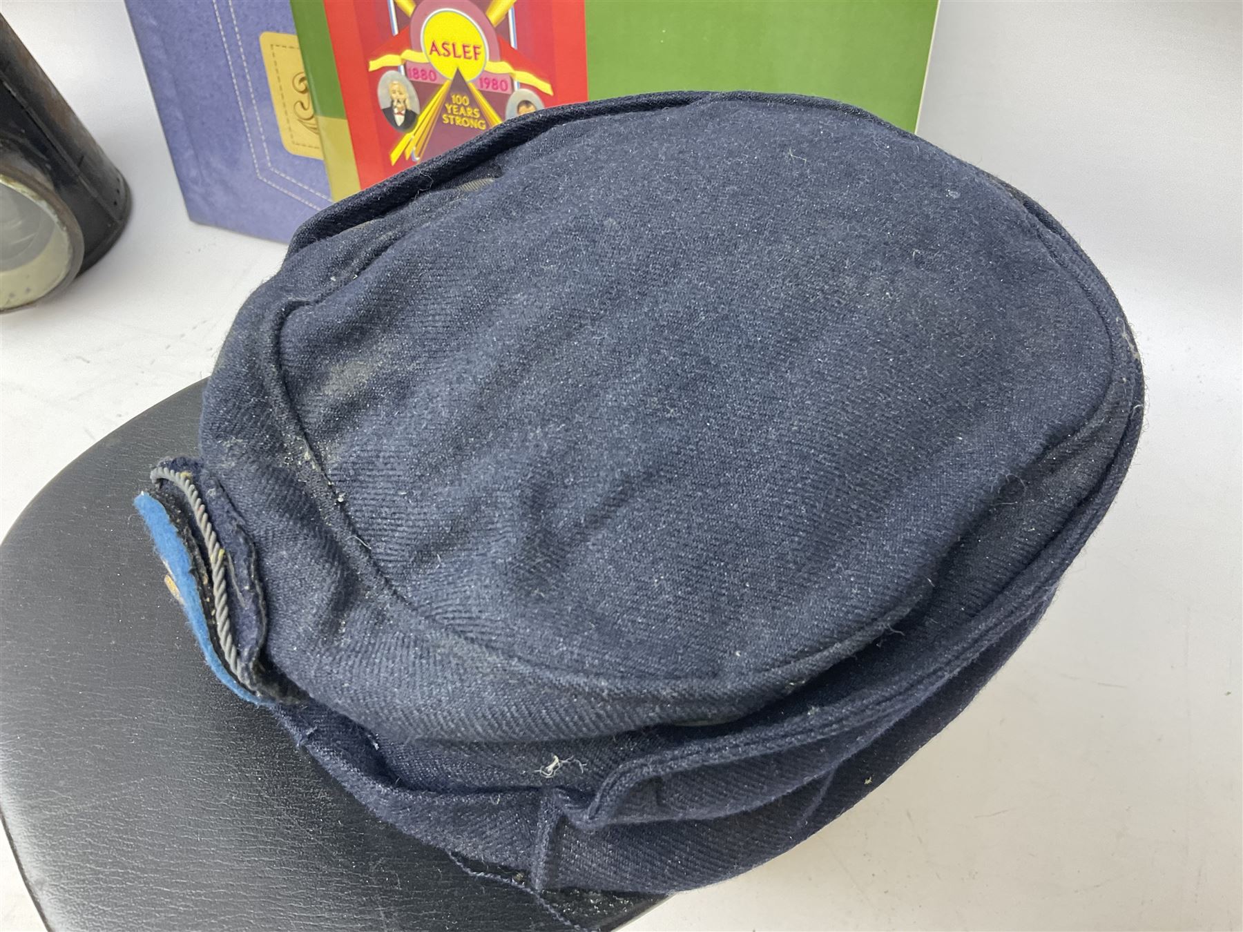 Black painted three colour railway lamp with revolving filters, H29cm; BR Acme Thunderer whistle; three railway peaked caps, two with BR Intercity 125 badge; small album of photographs of railway interest etc