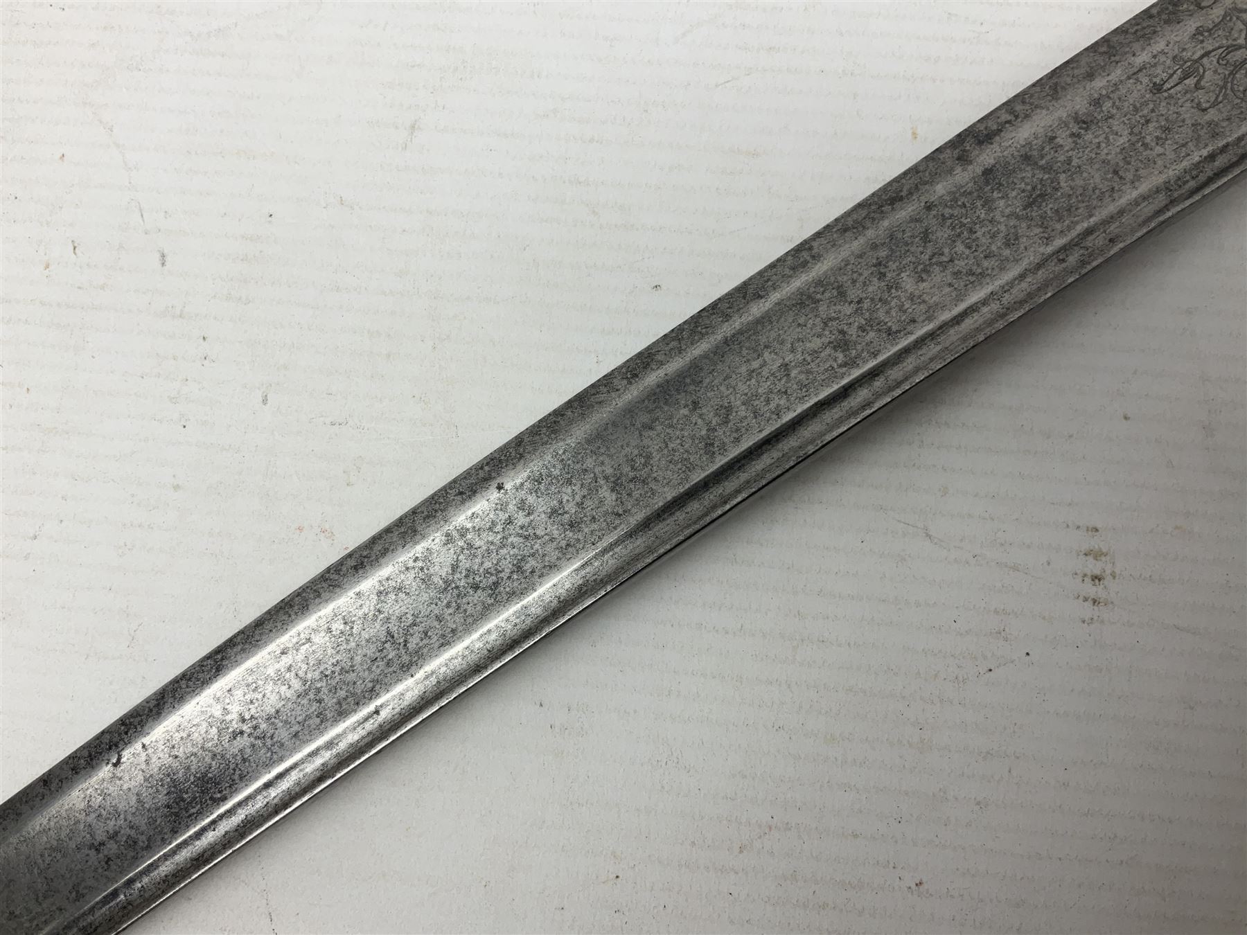 Late 18th century sword, the Spanish 79.5cm curving fullered blade engraved with the Royal Cypher, battle trophies and 'Viva Espania' banner, French Sabre de Mineur brass three-bar hilt with ebonised reeded grip L93.5cm overall (no scabbard)