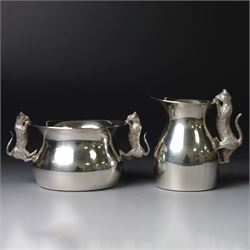 Modern silver cream jug and sugar bowl, each of waisted plain form, the handles modelled a...