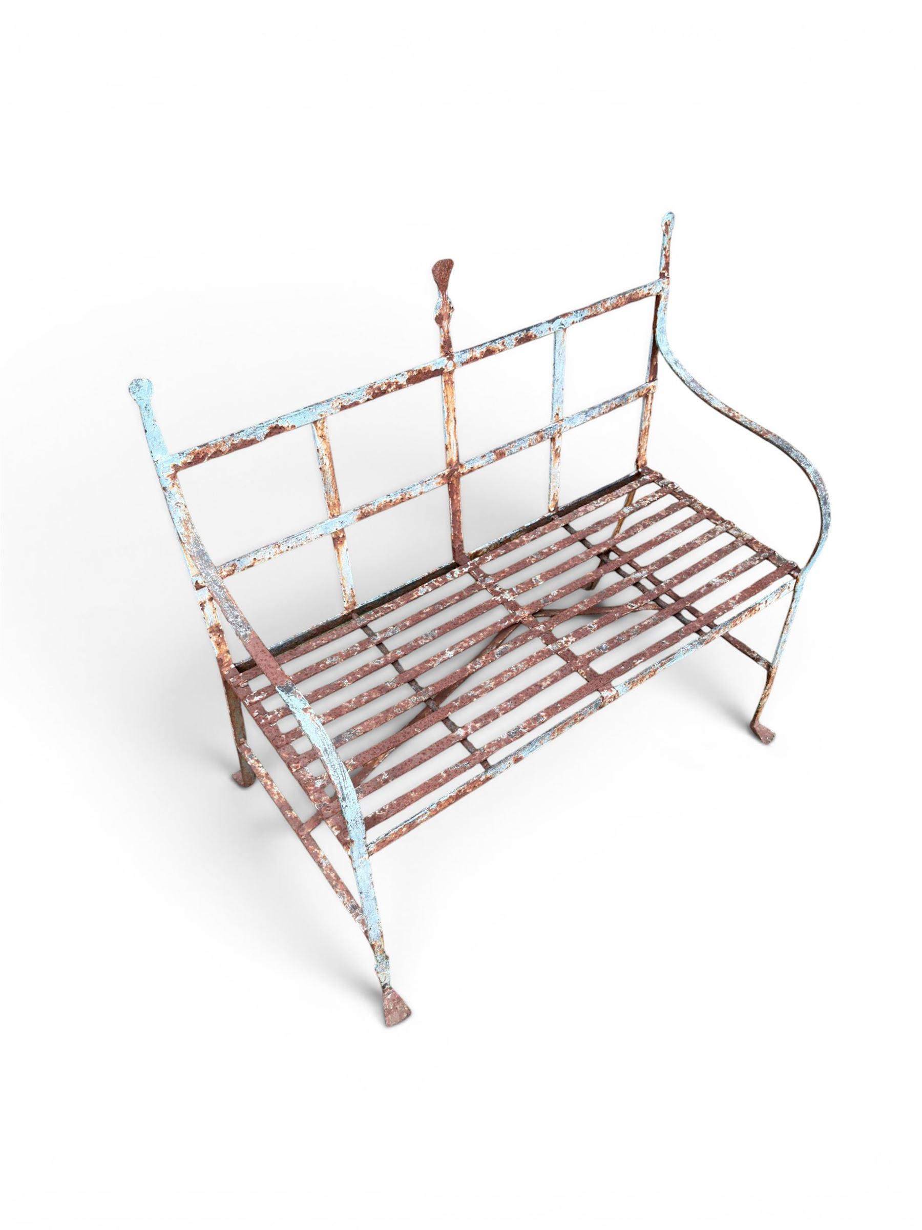 Regency period wrought iron strapwork garden bench, cresting rail with central Scottish thistle motif and flanking pediments, in distressed blue painted finish