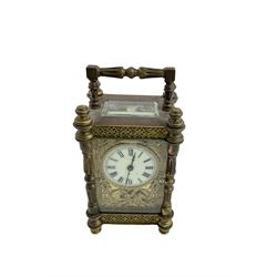 French - Edwardian timepiece 8-day carriage clock with original case, highly ornate brass case with filigree panels and shaped columns to the corners, conforming art deco designed dial mask and circular enamel dial with Roman numerals and matching steel arrow hands, single train movement with a platform cylinder escapement.