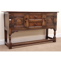  Jacobean style oak sideboard, two carved panel doors flanking two drawers, turned supports joined by stretchers, W146cm, H84cm, D44cm  