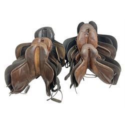 Collection of nine saddles, mainly havana leather to include a racing saddle and a Goodwin saddle, some with stirrups and leathers 