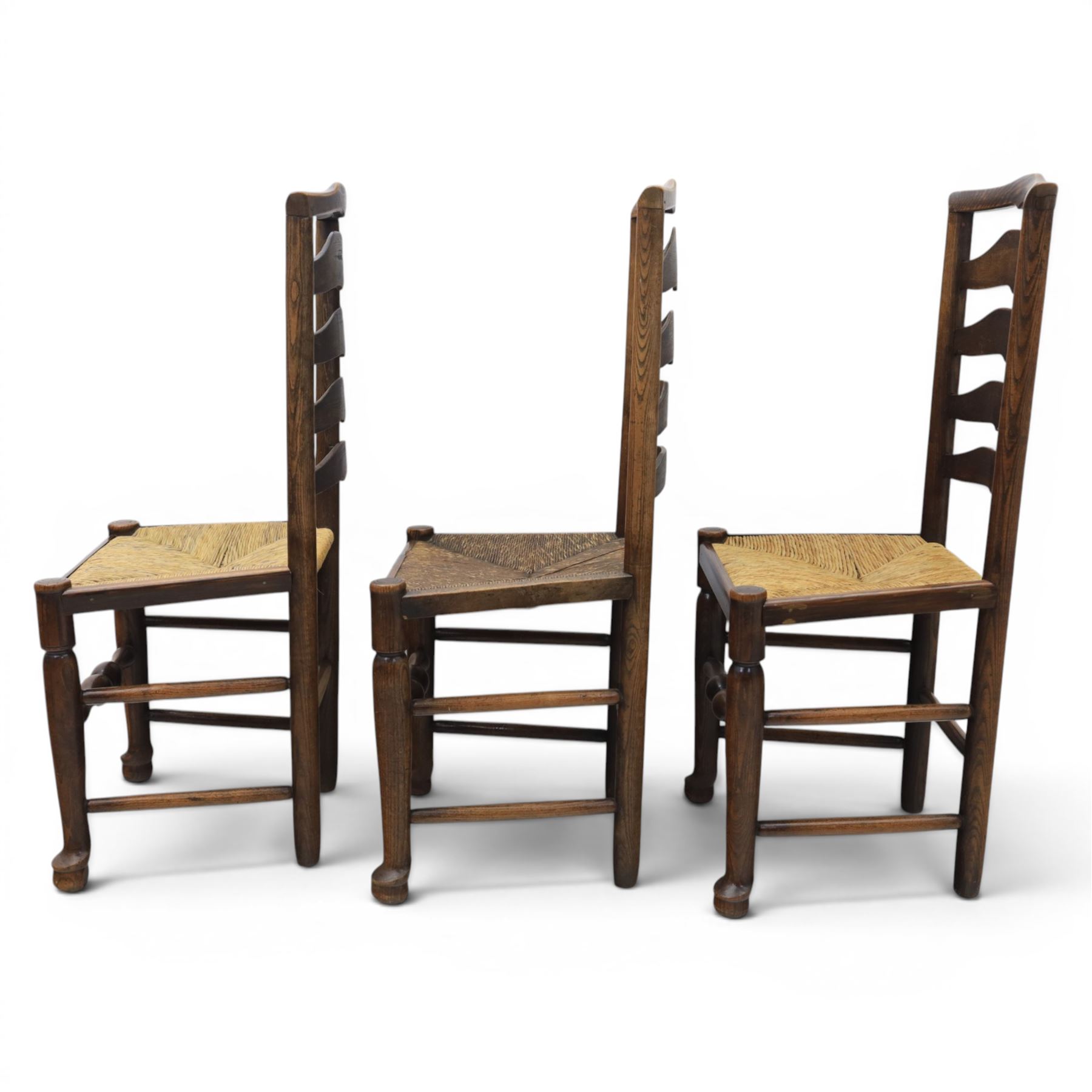 Set of seven (6+1) Georgian design country elm Lancashire dining chairs, ladder backs with rush seats, turned front leg stretcher on pad feet, height of seat 44cm, complete with fitted tie on cushions