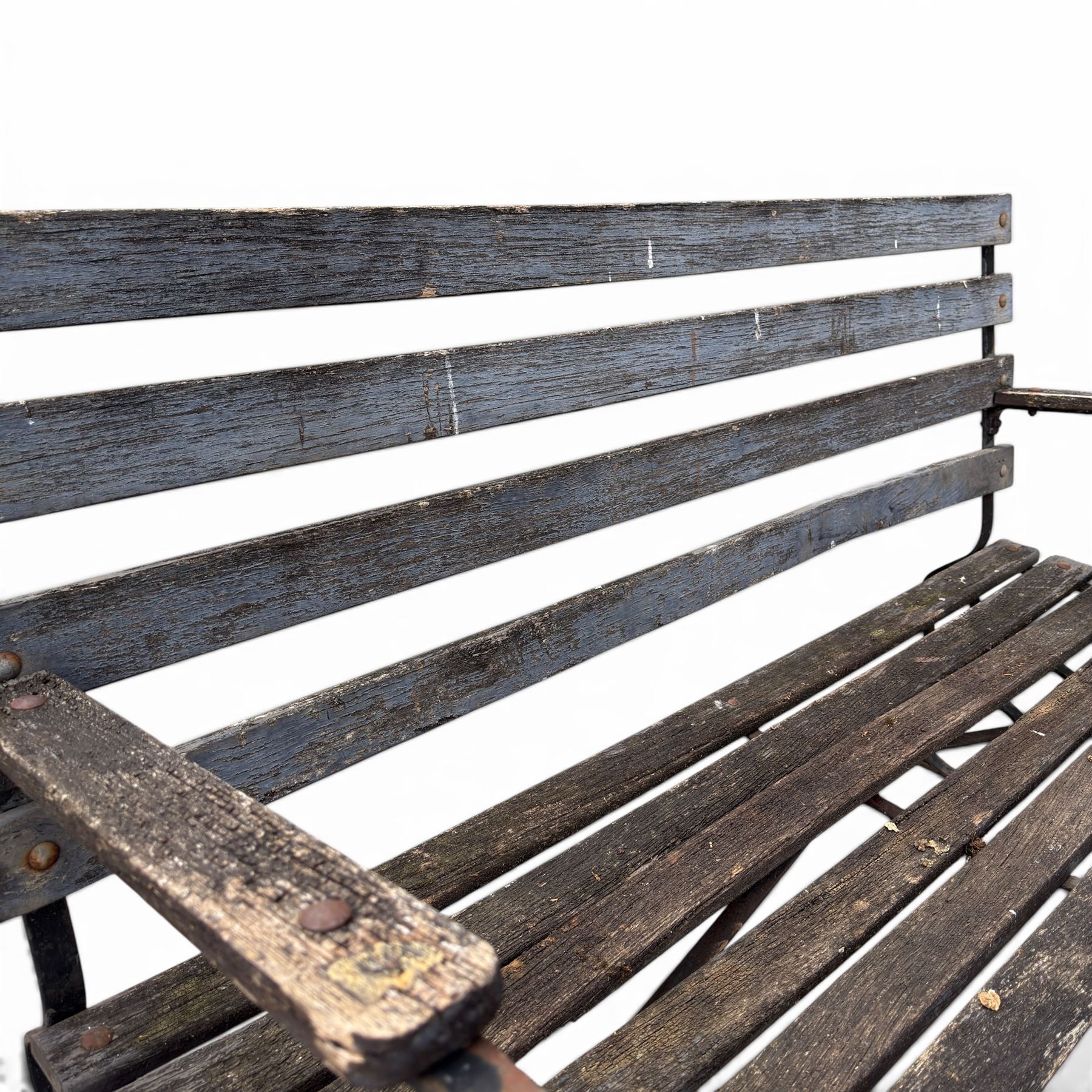19th century wrought iron strapwork and slatted wood garden bench, the arm terminals and end supports of scrolling form
