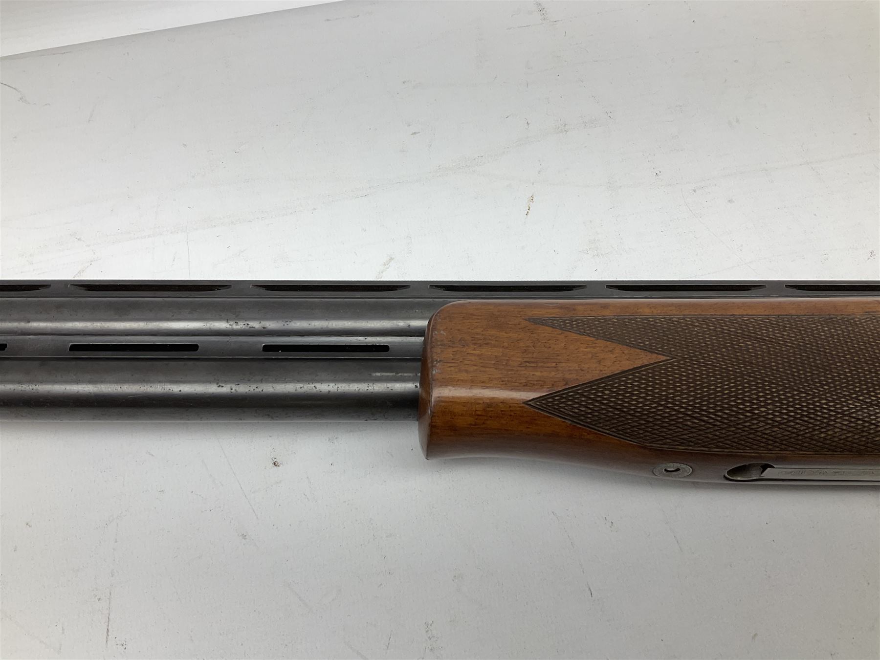 Winchester Japan 5500 12-bore by two-and-three quarters over-and-under double barrel boxlock ejector sporting gun, with 71cm barrels, ventilated rib and barrels, the walnut stock with chequered pistol grip and fore-end, single selective trigger and top safety, serial no.K542927E, L115cm overall; in gun sling SHOTGUN CERTIFICATE REQUIRED