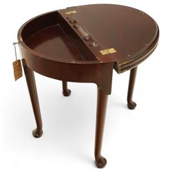 20th-century Georgian Revival style double fold-over card table, the first hinged circular top with polished mahogany surface above a second hinged circular top revealing a green baize playing surface with four counter-wells, underneath with a recessed compartment with and  chip and dice wells, the apron with fitted lock and key, raised on slender straight legs with pad feet 