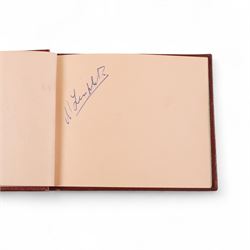 1950s autograph book, containing mostly motorcycle racing signatures, including four-time World Sidecar Champion Eric Oliver, 1952 Sidecar World Champion Cyril Smith and1955 Junior TT Champion Jack Bailey, in red leather case with gilt lettering 