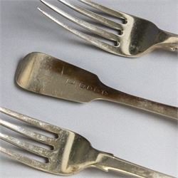 Seven silver Fiddle pattern table forks, comprisng set of four William IV examples, hallmarked William Eaton, London 1836, and three Victorian examples with engraved initials, hallmarked John Robert Harris, London 1846