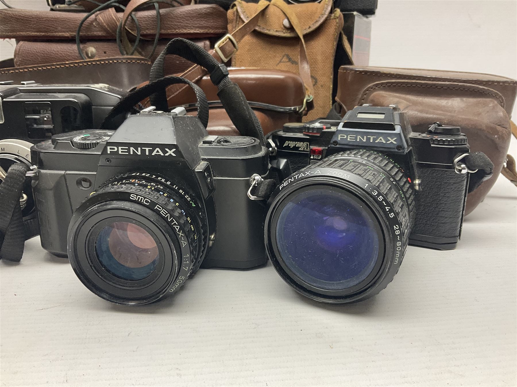 Collection of cameras and lenses, to include Pentax Program A camera body, serial no 123759, with 'Pentax-A zoom 1:3.5-4.5 28-80mm' len, Praktica EE2 camera body with 'Pentacon electric 1.8/50' lens etc, together with a Manfrotto tripod 