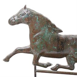 Copper weathervane formed as a leaping horse, mounted upon naturalistic base, W77cm
