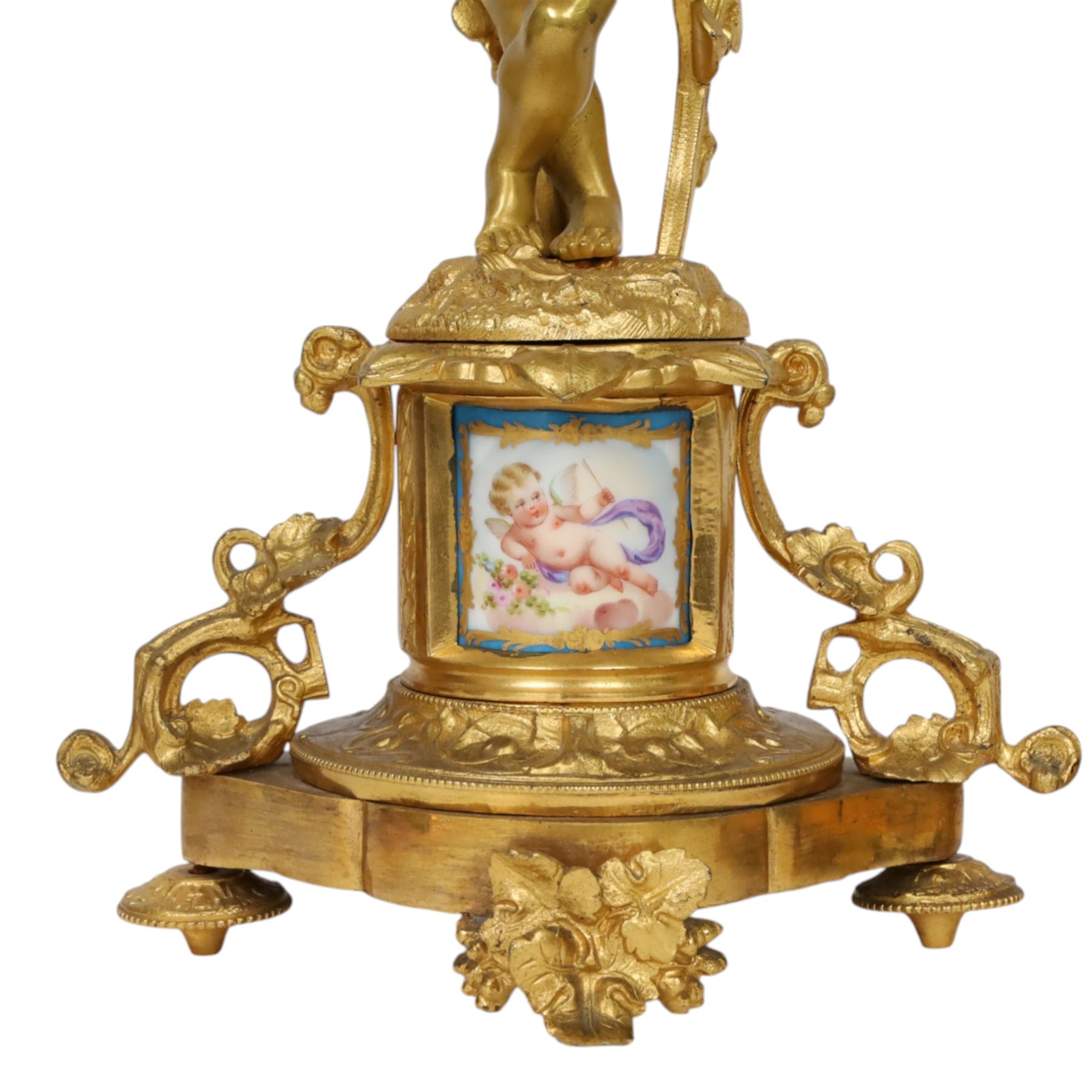 Pair of 19th century ormolu putto figures, each modelled stood with foliate support to backs, upon a naturalistic base upon cylindrical plinth each with twin leafy tendril supports, each plinth with inset Sevres type painted panel of a cherub, upon a shaped base with four compressed disk feet, the front facing with leaf mount, H29cm