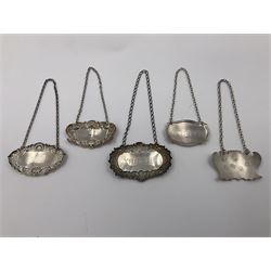 Five modern silver decanter labels, to include two sherry examples, embossed with scrolls and fruits, hallmarked W I Broadway & Co, Birmingham 1991 & 1997, a similar claret example, hallmarked S J Rose & Son, Birmingham 1973, and two plain shaped port and burgundy examples, hallmarked C Robathan & Son, Birmingham 1997 and A Haviland-Nye, London 1968