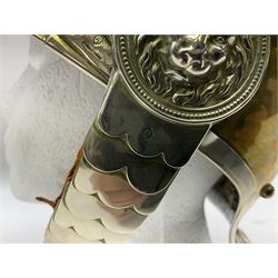 Early 20th century French mounted gendarme's helmet, brass with nickel-silver mountings, broad band embossed with fused grenade, high comb with the face of the gorgon Medusa at the peak and with a black horse hair crest, plume socket at the left, leather-backed nickel-silver chin scales with lion mask mounts.