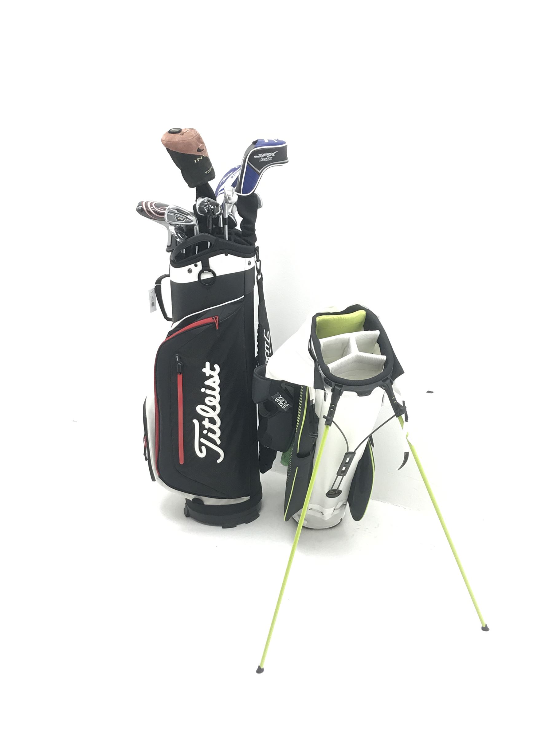 A quantity of TaylorMade golf clubs and others and two bags 