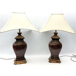 Pair Oriental table lamps decorated with birds in a tree with fruit, on a red ground with a gilded base together with cream lampshades H57cm, without lampshade. 