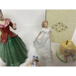 Two Coalport cottages, comprising Teapot cottage and Easter Cottage, together with four Royal Doulton figures, including Holly and Friendship 