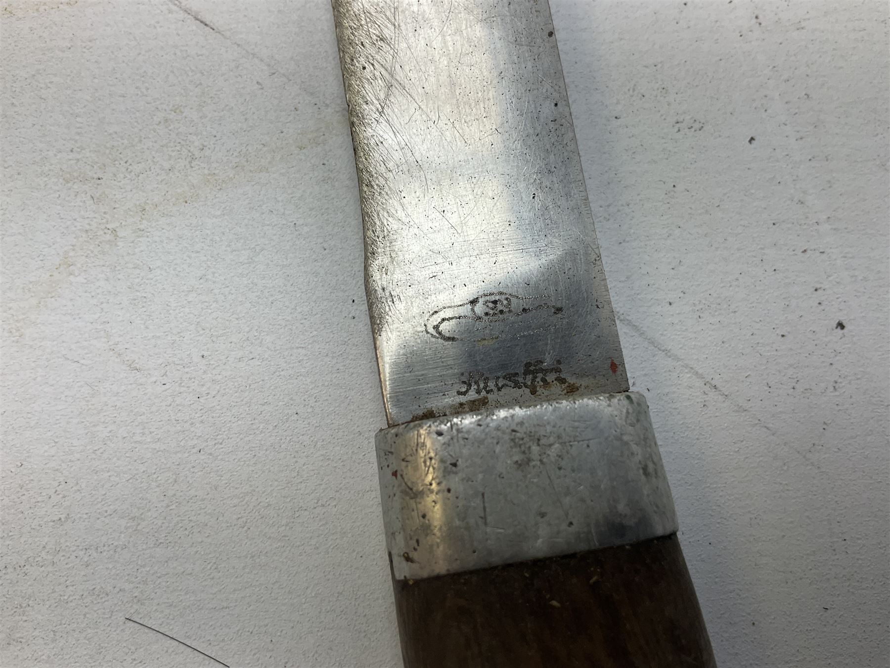 Burmese dha dagger with 15cm steel blade, white metal ferrule and horn handle, in white metal and filigree scabbard L30.5cm; a Burmese long bladed knife with horn handle and brass mounted teak scabbard; and another Eastern dagger in sheath (3)