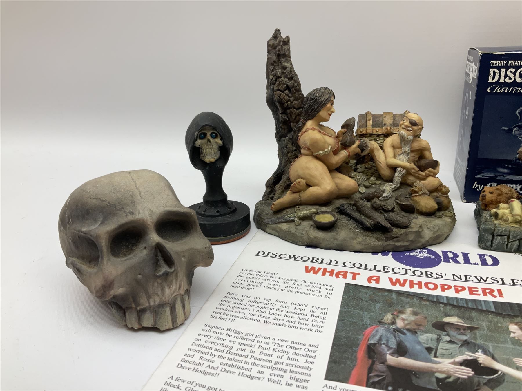 Terry Pratchett Discworld figures, designed by Clarecraft, comprising Cohen the barbarian, DW42, the Patrician, boxed, DW37, three Potions, DW18, DW19, DW20, two Death Bookstamps, DW50, the Gods Dice Box, boxed, DW26, together with two Discworld newsletters, volume 5, August 1998 and volume 6, August 1999. 