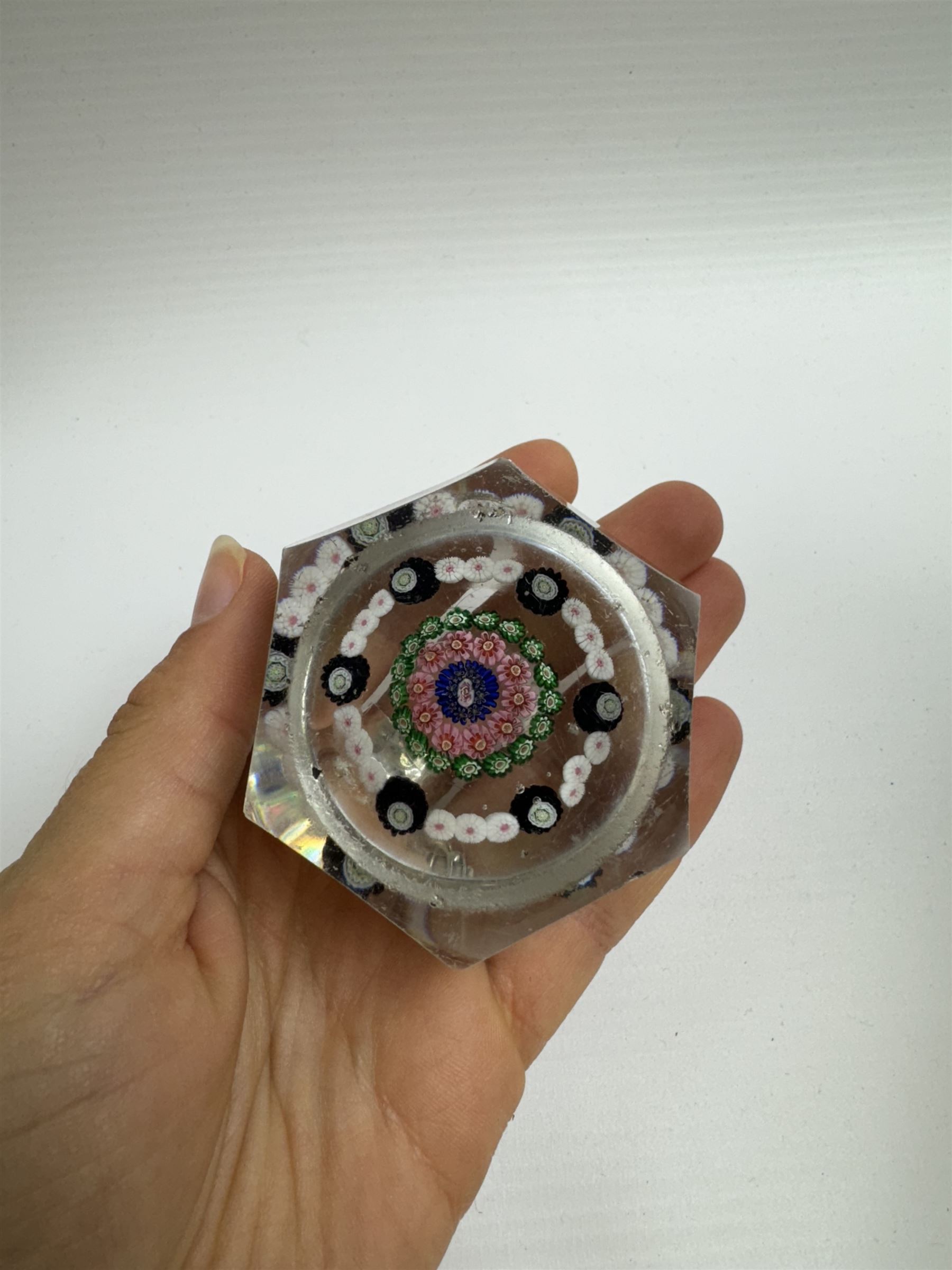 Glass Millefiori paperweight of hexagonal faceted form, H5cm