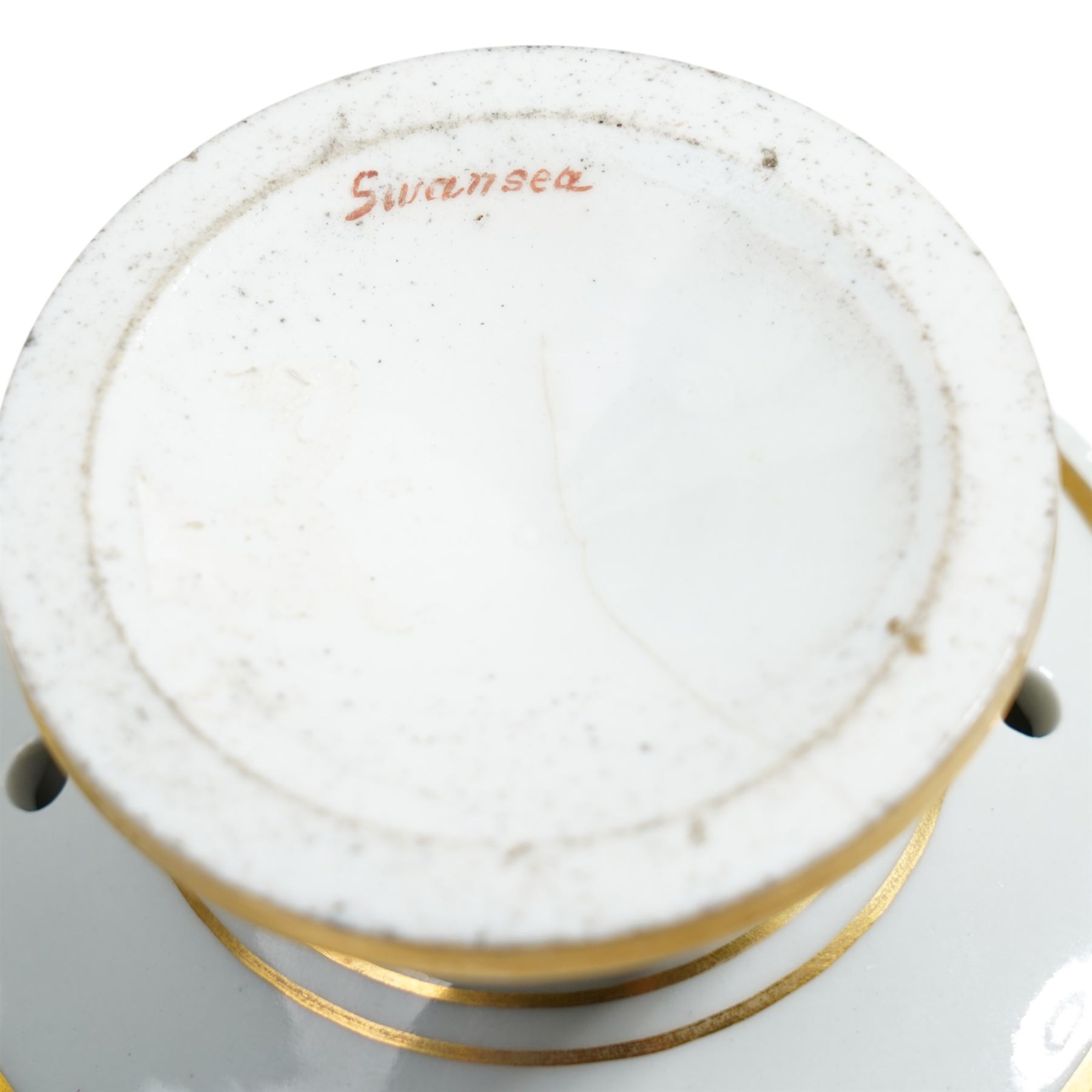 Pair of early 19th century potpourri, possibly Swansea, with twin gilt mascaron handles, the body painted with flowers on a gilt ground, spurious mark in red to base, H13cm  