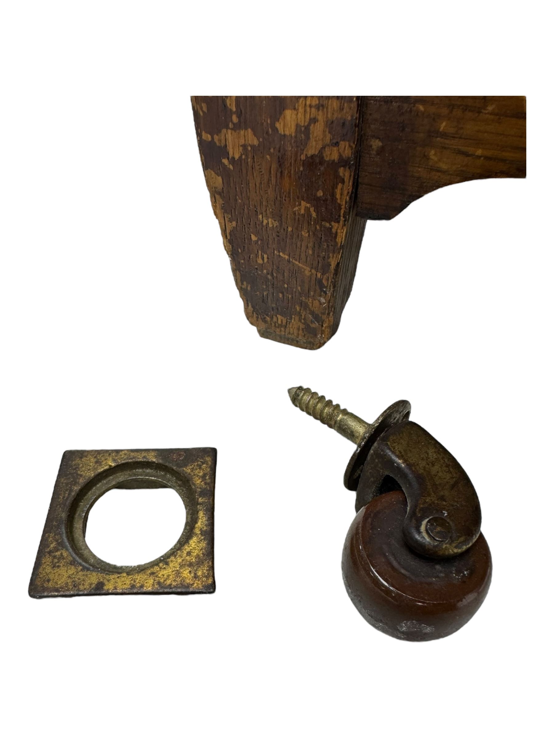 Early 20th century Arts and Crafts oak dressing chest, the arched mirror flanked by floral marquetry inlaid uprights above a shelf and drawer, over three long drawers with square hammered metal plates and circular pulls, on slender supports with castors