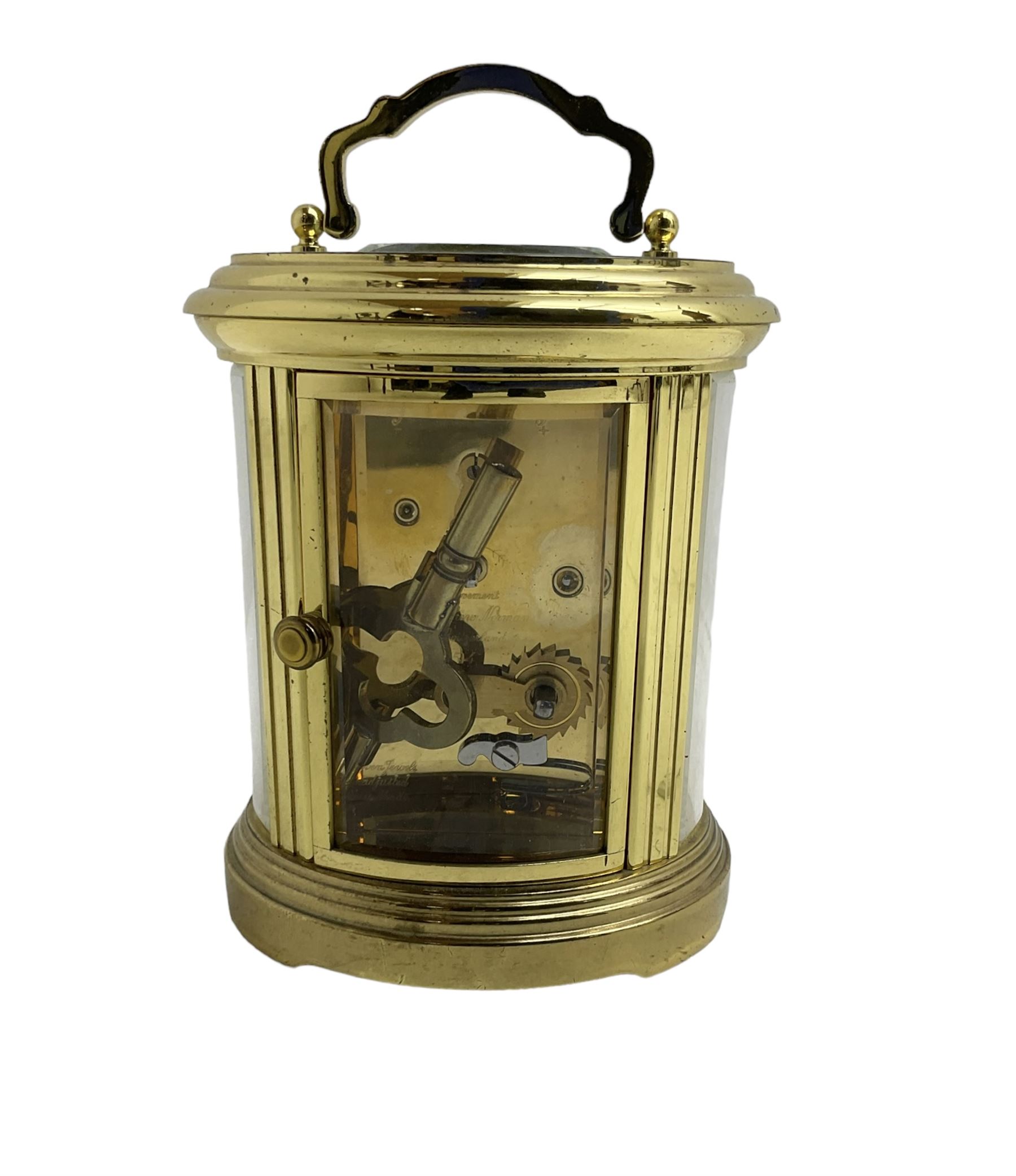 English - 20th century  8-day oval carriage clock, in a polished gilt case with an enamel dial, Roman numerals and moon hands, dial inscribed Mathew Norman, London, timepiece spring driven movement with a lever platform escapement, balance with timing screws. 