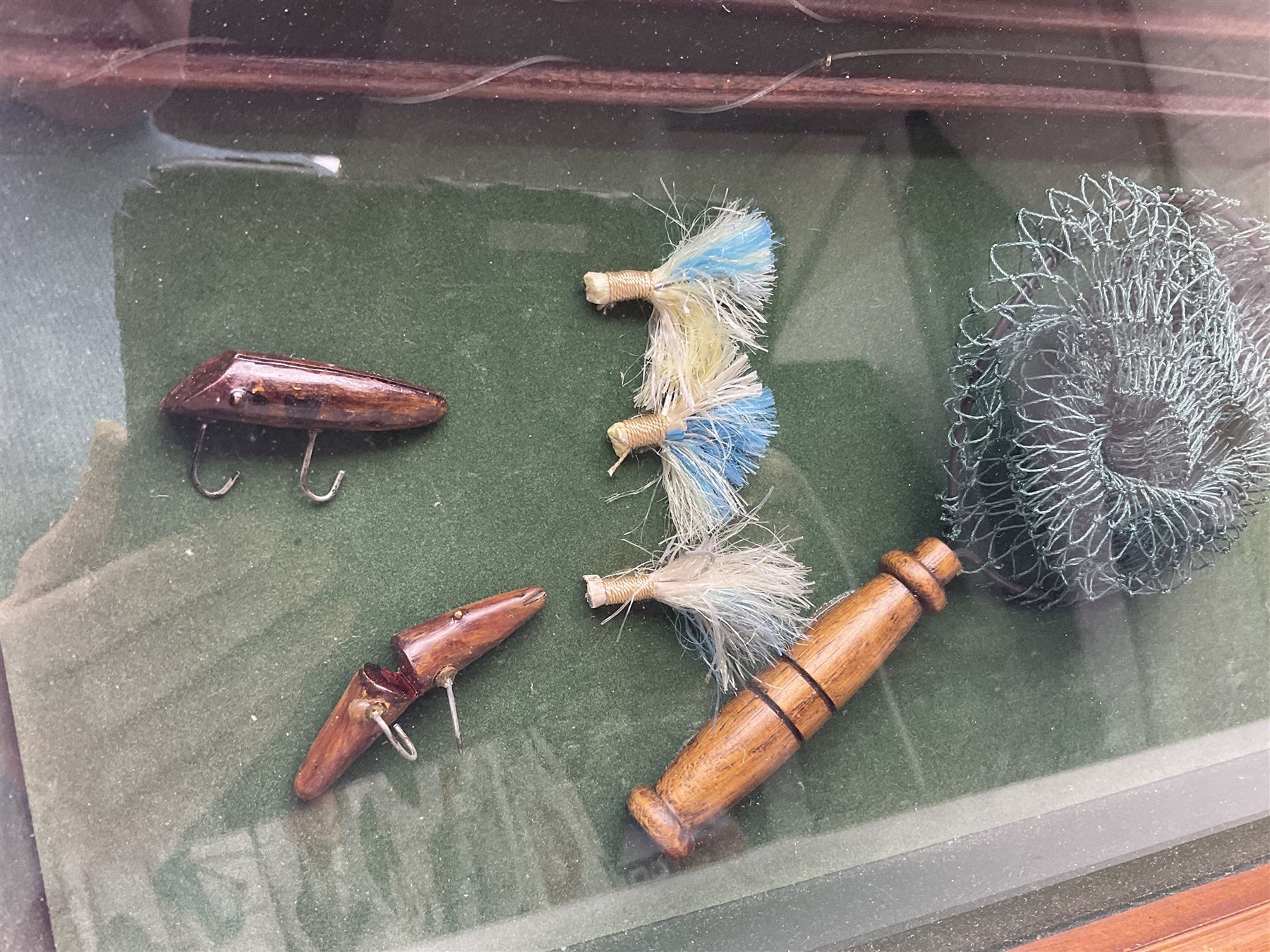 Four framed sporting memorabilia displays, the largest example containing 1930s cricket memorabilia, together with two fishing displays and a football display, each within wooden glazed frames, largest H105cm