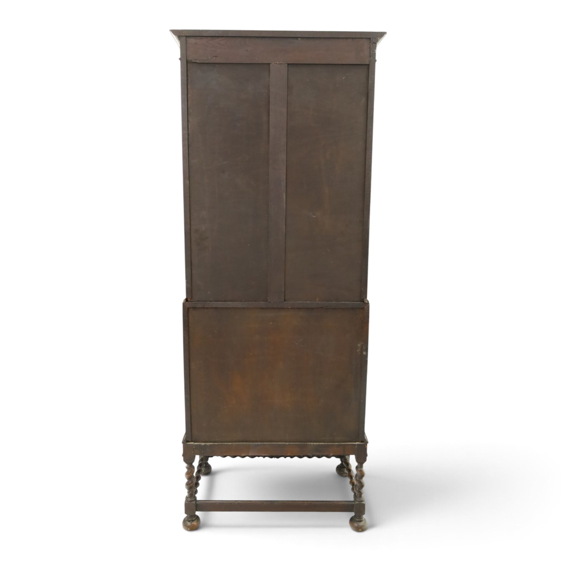 Early 20th century Jacobean Revival oak bureau-bookcase, astragal glazed doors enclosing two adjustable shelves, over geometric panelled fall-front enclosing fitted interior, over two drawers, raised on a spiral-turned base with barley-twist stretchers and compressed bun feet