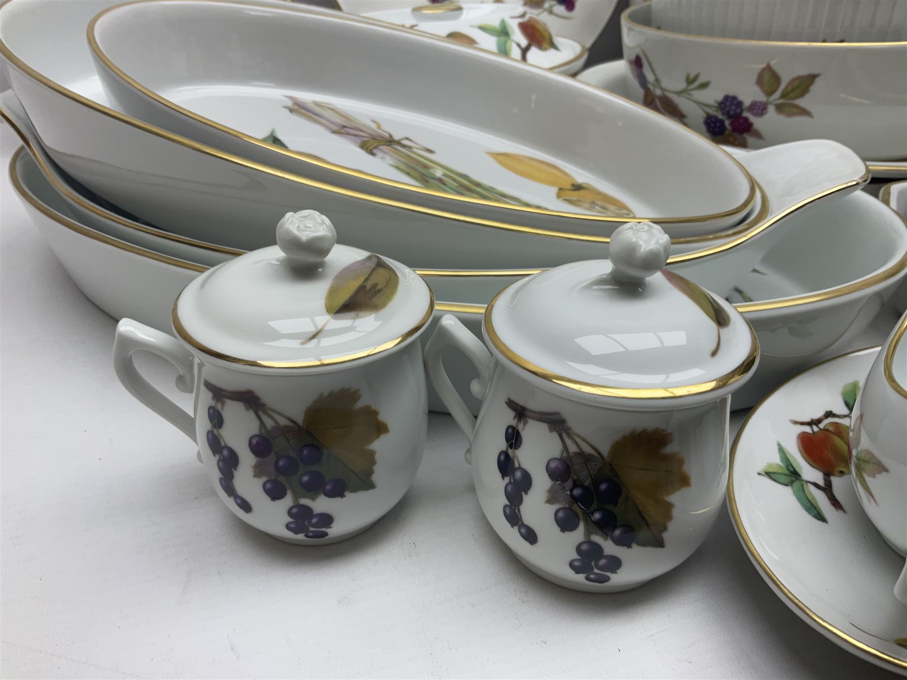 Royal Worcester Evesham pattern, including covered pot de cremes, twin handle tureen, serving dishes, flan dishes, side plates etc  