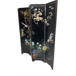 Oriental four fold screen, the black lacquer panels carved and painted with red headed cranes, birds upon blossoming branches and flowers