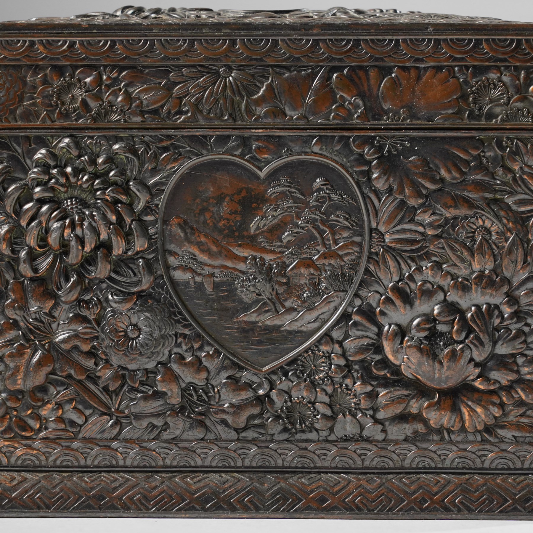 Japanese Meiji period bronze playing card box, decorated with intricate repoussé floral motifs, marked to base