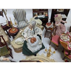 Dolls house living room and ding room furniture, including sofa, chair, long case clock, Christmas trees, fireplace, dresser, chairs, tables, mirrors, seven figures and a collection of predominantly Christmas themed decorations, food, etc