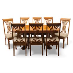 Late 20th century parquetry veneered extending dining table and eight chairs, the rectangular top with canted corners decorated with geometric parquetry panels, moulded edge frieze with repeating carved detail, raised on twin pedestal supports with fluted columns and shaped platform bases, the chairs with pierced splat backs and upholstered drop-in seats
Extends on a central leaf to 208cm
