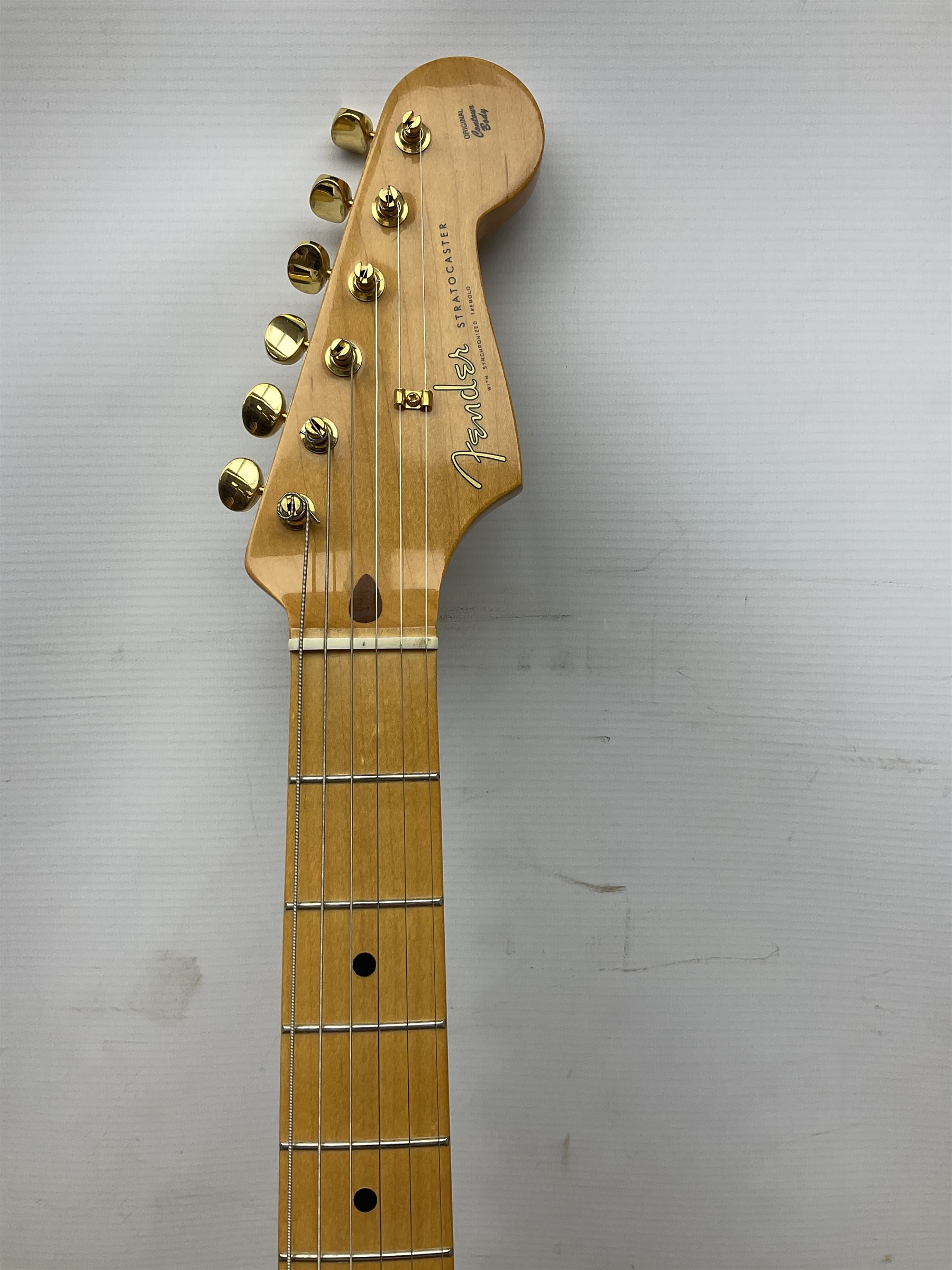 Fender Stratocaster 50th Anniversary 2004 metallic gold electric guitar; serial no.MZ4116369; L98cm; in Spider fitted case with owners manual and other paperwork, strap and belt buckle etc