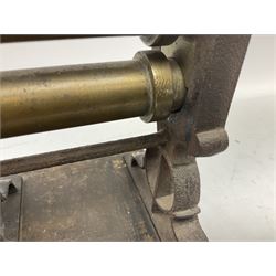 Victorian cuff and collar tabletop mangle, the ribbed brass rollers in a cast iron frame mounted on a wooden base