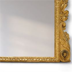 19th century George III style giltwood overmantel mirror, the rectangular bevelled plate within a moulded frame decorated with acanthus leaf and floral scroll carving to the corners, and sides flanked by two girandole sockets 