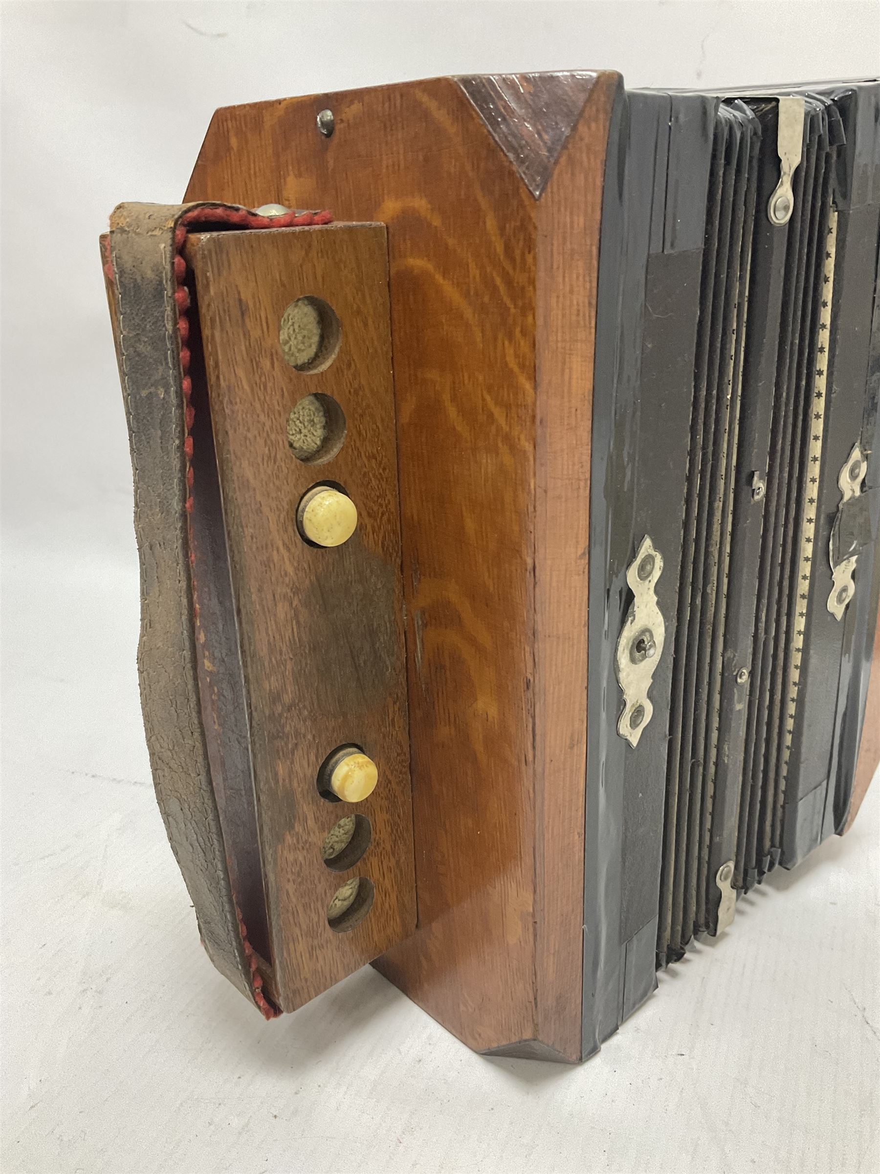 Three European concertinas, comprising Viceroy German concertina with 21 keys, hexagon wooden frame and 8 fold bellows
Oak framed concertina with 12 keys and 8 fold bellows
Commander concertina with 12 keys and 12 fold bellows
With tutor