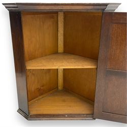 Early 20th century wall mounted oak corner cabinet, moulded cornice over panelled door enclosing single fixed shelf (W60cm, D40cm, H66cm); 19th century oak corner cabinet, panelled door enclosing three shaped shelves (W65cm, D35cm, H92cm)