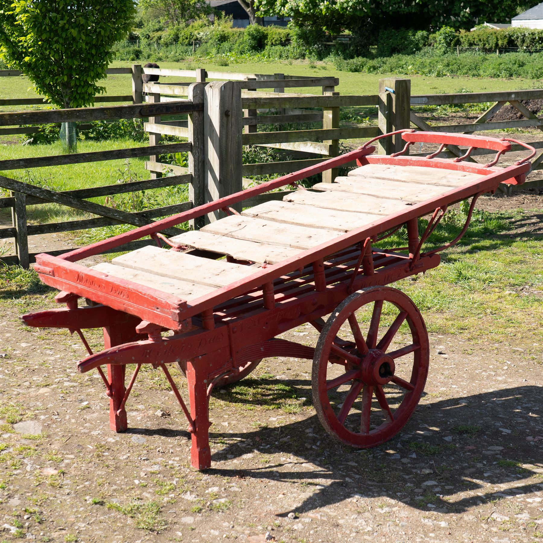 Costermonger’s Cart

A painted costermonger’s cart with red timber frame, slatted deck and wooden spoked wheels. The cart has long hand rails, raised side rails and turned supports, with incised inscriptions to the frame, including “Meyers Bros”. The form is consistent with a hand drawn market cart, used for carrying and displaying produce or goods.

Features:
Red painted timber frame
Slatted wooden deck
Wooden spoked wheels
Long hand rails
Raised side rails
Turned timber supports
Incised inscriptions to the frame
“Meyers Bros” inscription visible
Traditional market cart form

Dimensions:
Length: 240 cm (body approximately 210 cm)
Width: 102 cm
Height: 92 cm

Wheel diameter: 67 cm