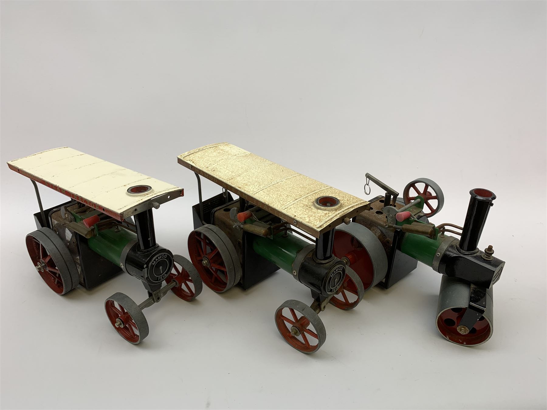 Two Mamod TE1A traction engines with steering rods; Mamod SR1 steam roller with steering rod; and Mamod lumber trailer, all unboxed (4)
