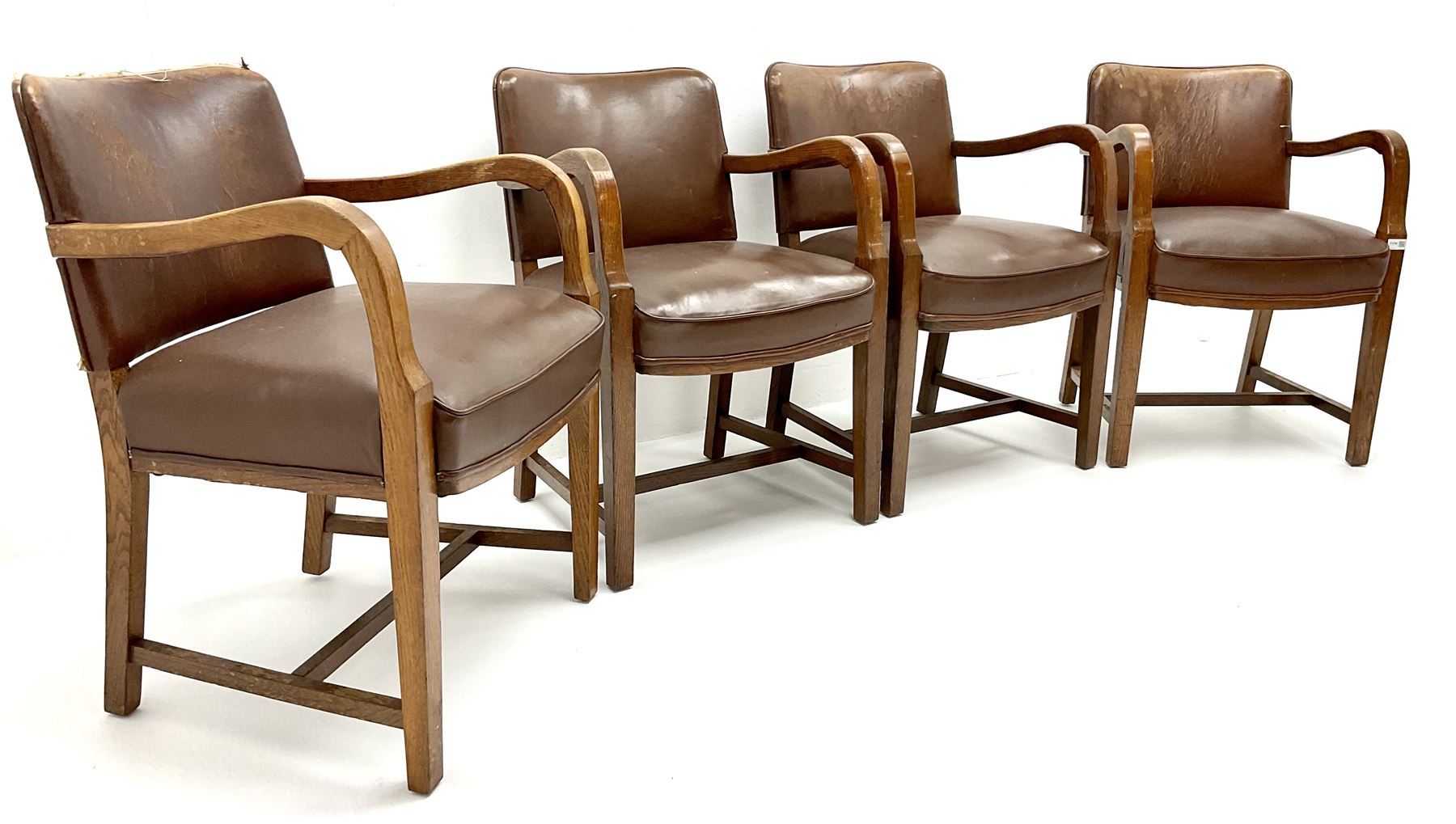 Set four mid century oak framed boardroom chairs, upholstered back and seat, shaped arms, square tapering supports joined by stretchers
