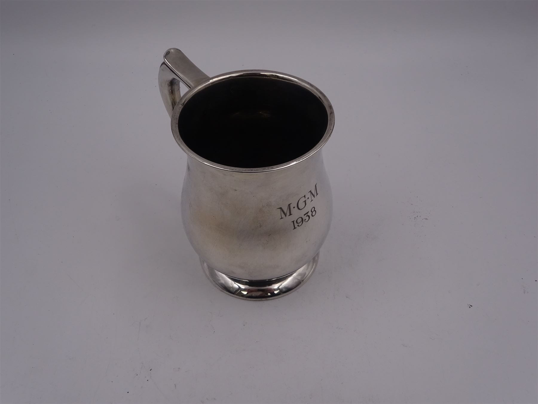 1930s silver tankard, of baluster form, with personalised engraving and C scroll handle, upon spreading circular foot, hallmarked Mappin & Webb Ltd, Sheffield 1938