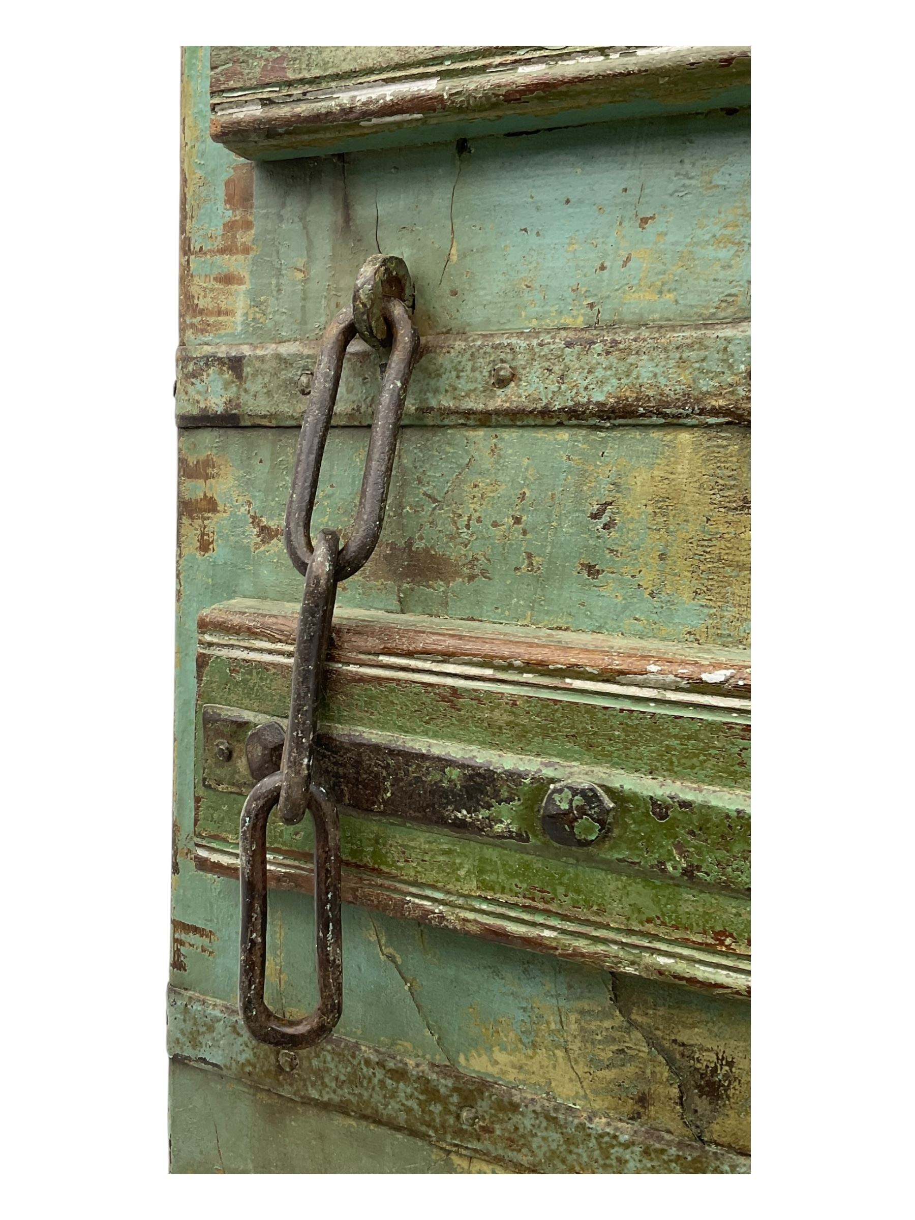 Pair of green-painted Indian doors, c.1860–1880, made from solid teak featuring original iron work and hand-painted finish