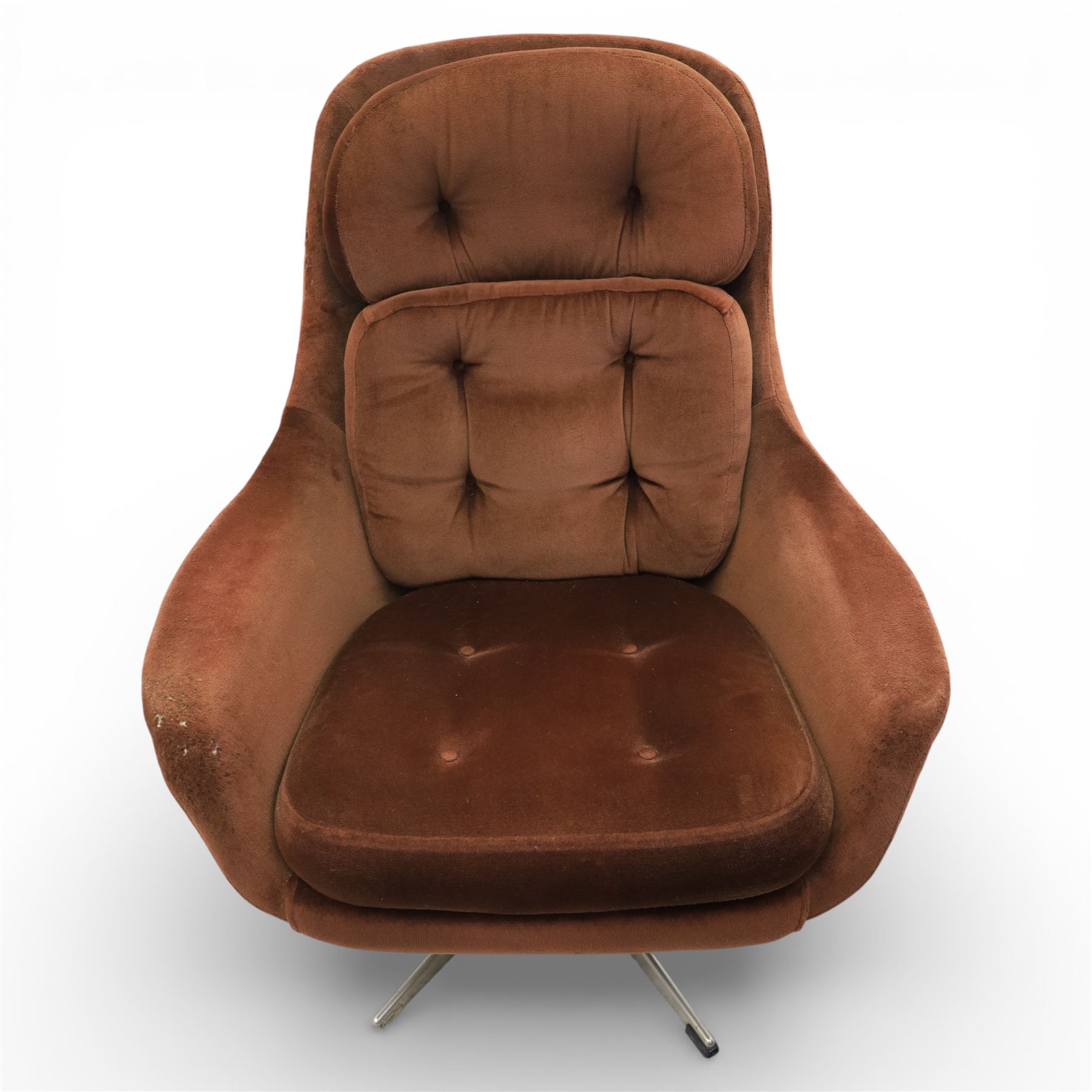 Pair of mid 20th century brown velvet swivel lounge chairs and matching footstool, the shaped and padded back with buttoned segmented cushion over conforming seat cushion, flared armrests and moulded sides, raised on a five point metal swivel base, the footstool en suite with buttoned cushion and matching metal base